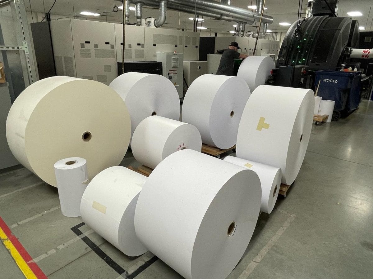 These massive rolls of paper will be loaded into printing presses (you can see one in the background of the photo)!