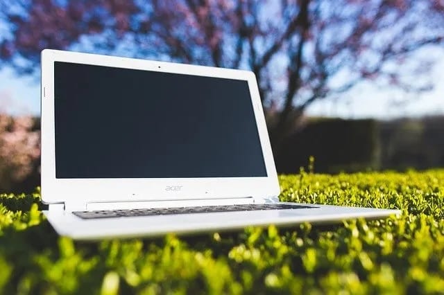 A laptop, for some reason sitting in the grass